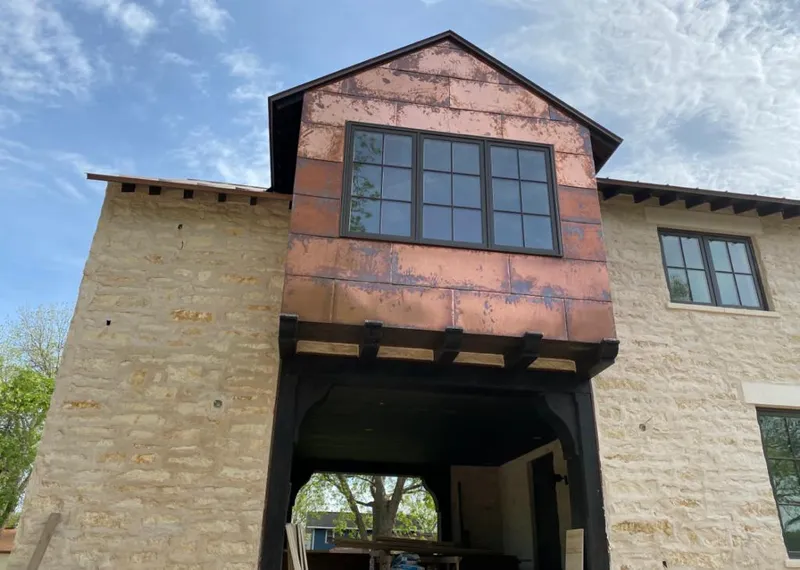 Copper metal panel facade on a stone building for Skylight Installation in Marrero