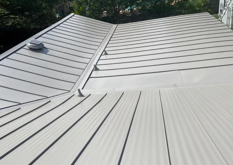 Solar attic fan installed on a metal roof for Roof Ventilation in Marrero